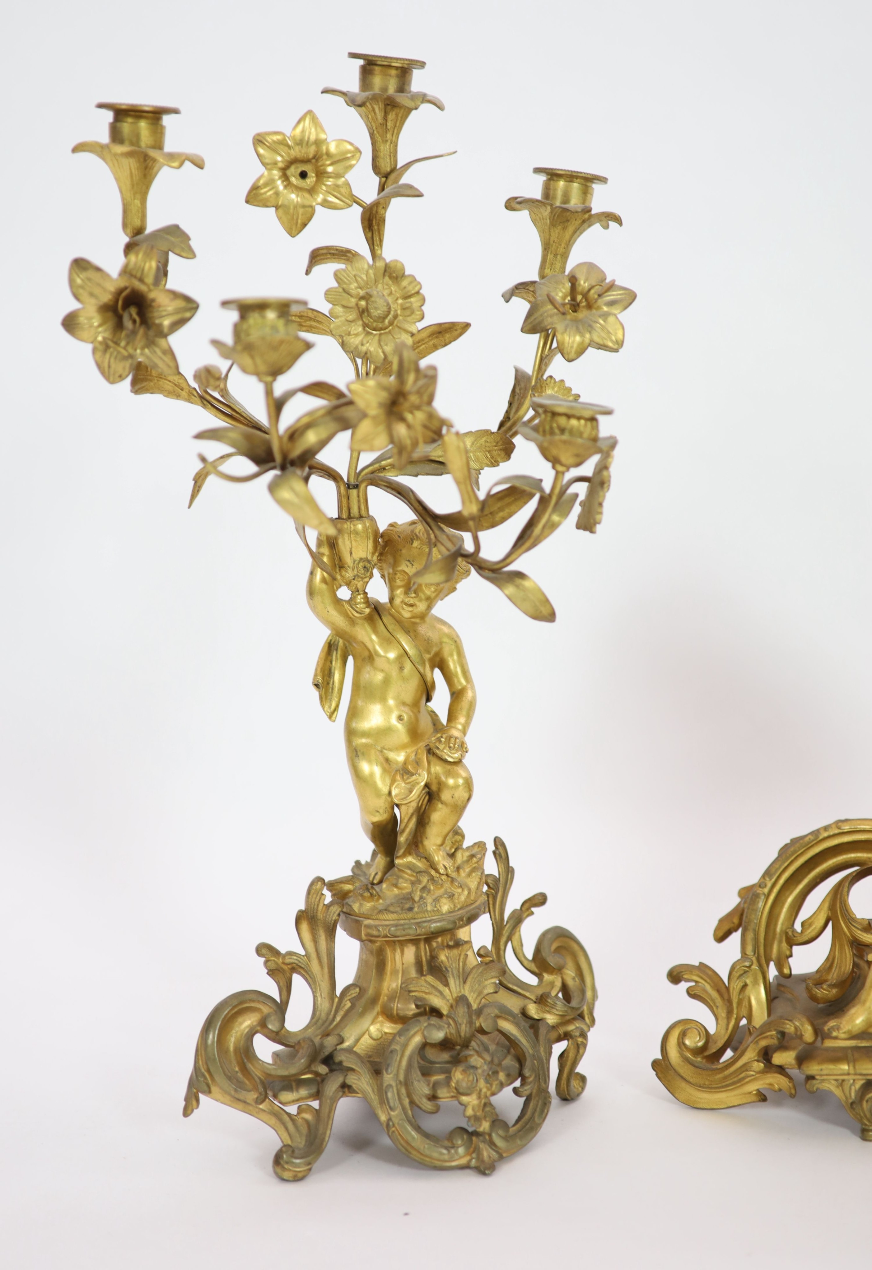 A 19th century Louis XV style ormolu clock garniture, clock H 43cm candelabra H 52cm